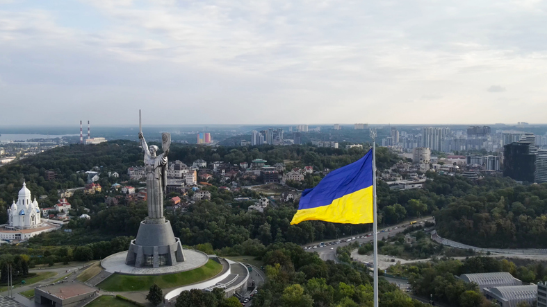 An aerial view of Kiev and the Motherland Monument in Kyiv (Kiev), Ukraine. Ukraine flag